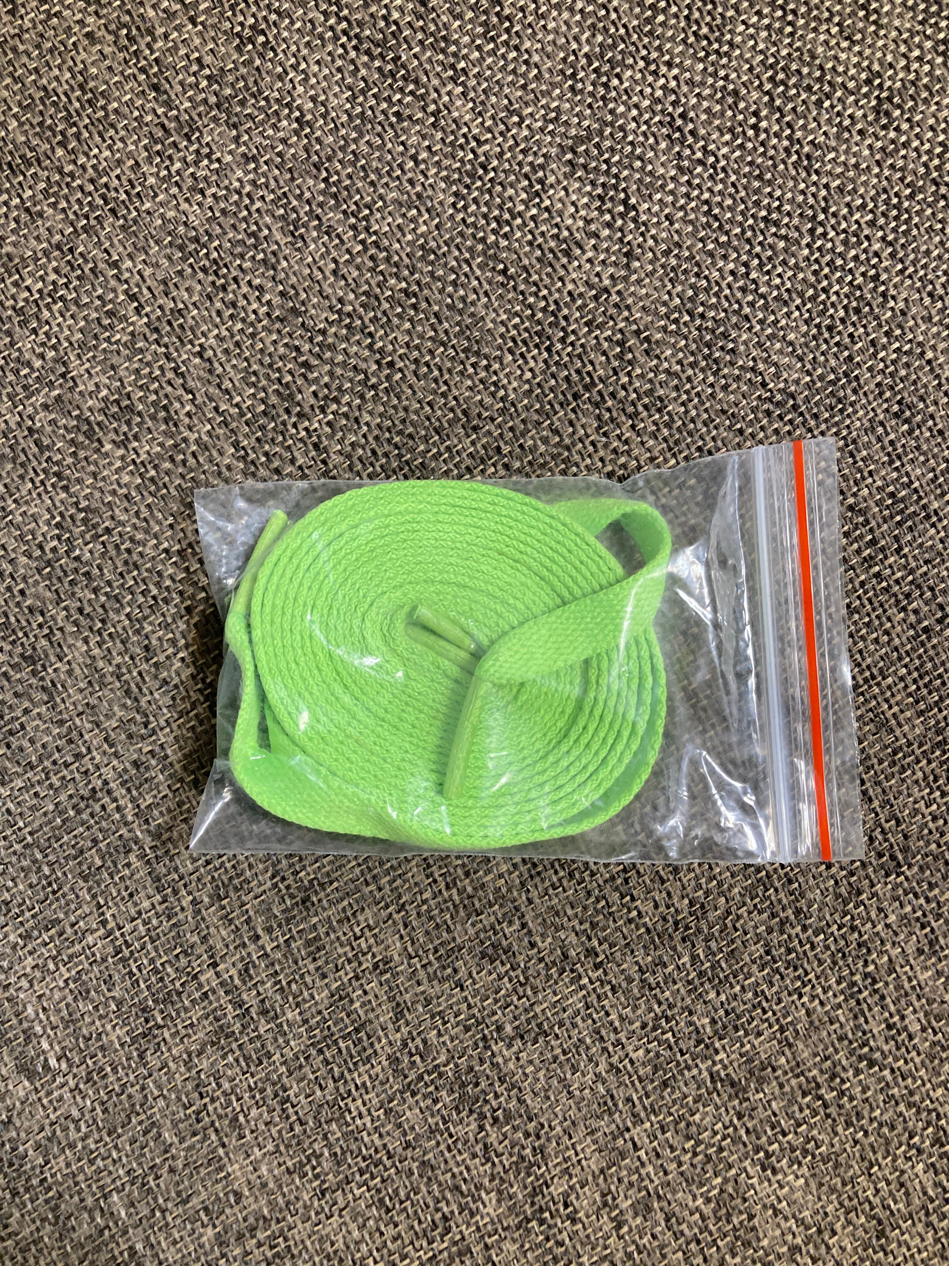 A pair of fluorescent green shoelaces